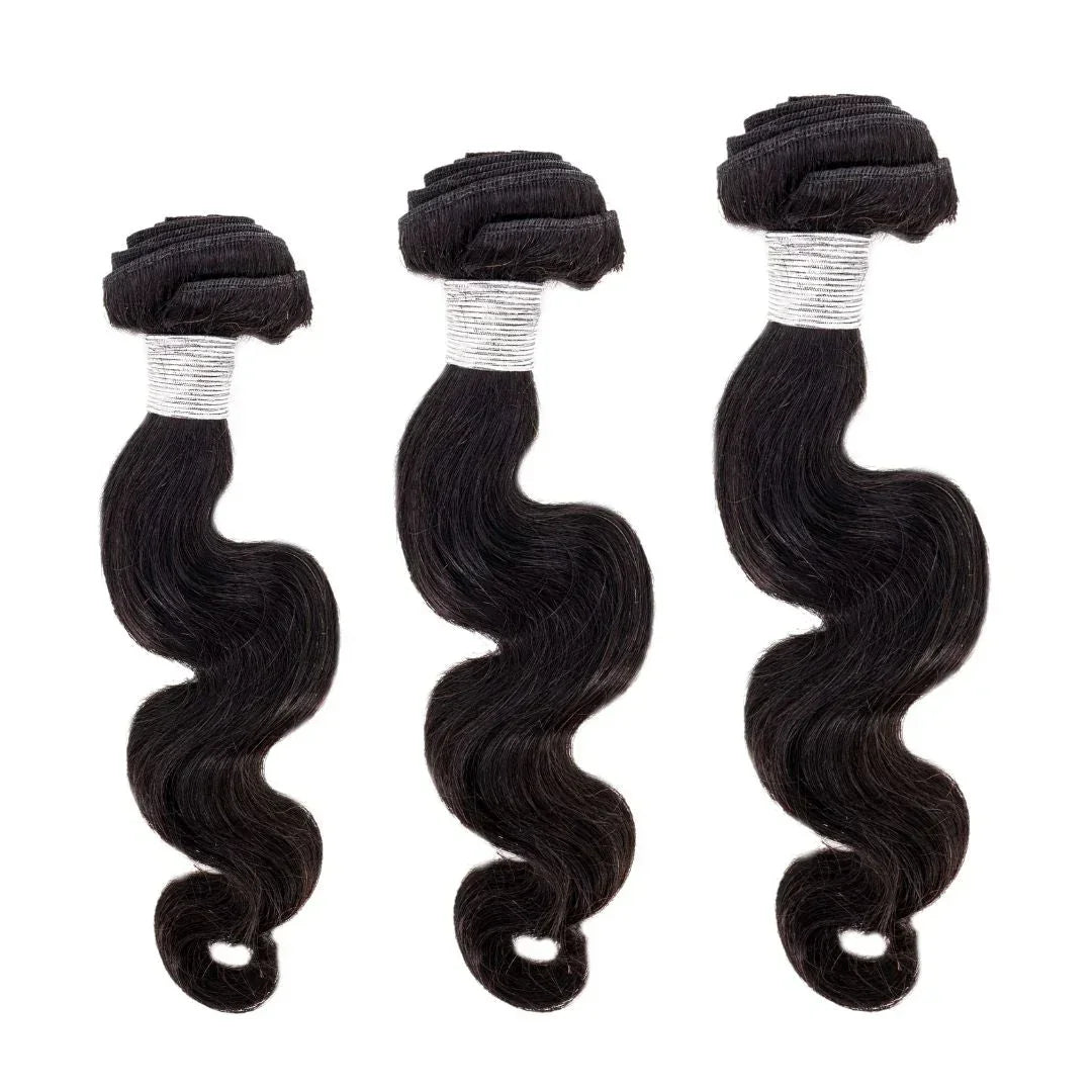 Three bundles of black Brazilian body wave hair extensions on white background