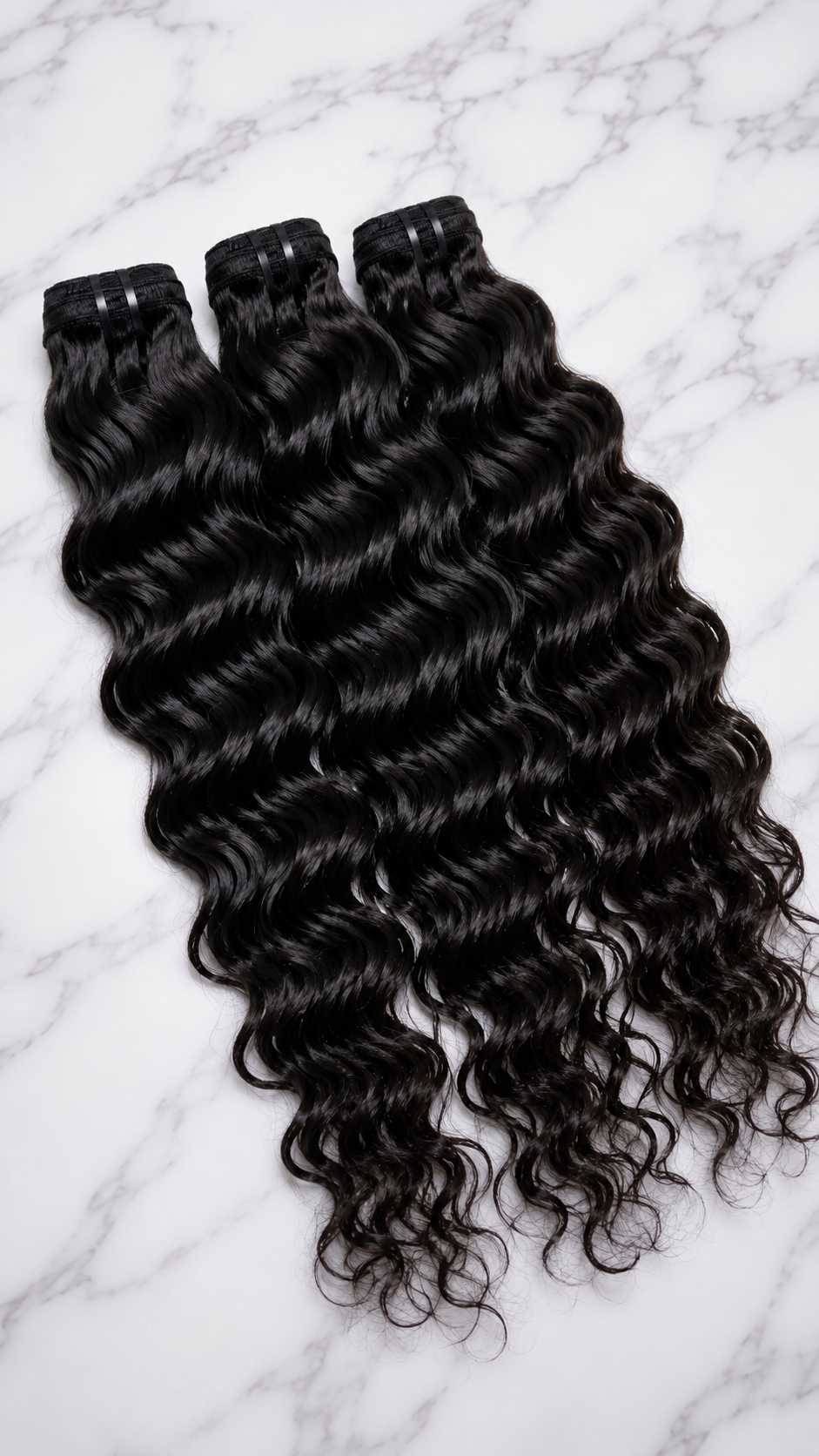 Water wave human hair bundles in natural 1B, available in 10 to 30 inch lengths, from Nikki Smith Hair Collection