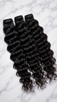 Water wave human hair bundles in natural 1B, available in 10 to 30 inch lengths, from Nikki Smith Hair Collection