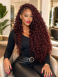 Woman with long burgundy curly hair extensions, hairstyle in modern salon setting