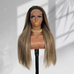 Front view of a straight balayage 5x5 HD lace wig with dark roots and blonde highlights on a mannequin.