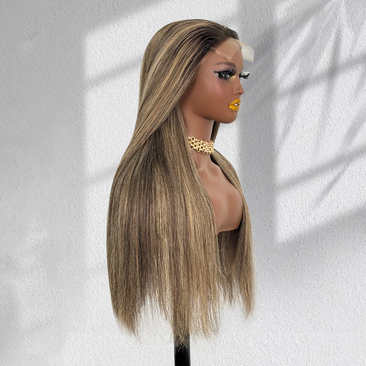 Right-facing side view of a straight balayage wig showing dark roots, blonde highlights and smooth ends.