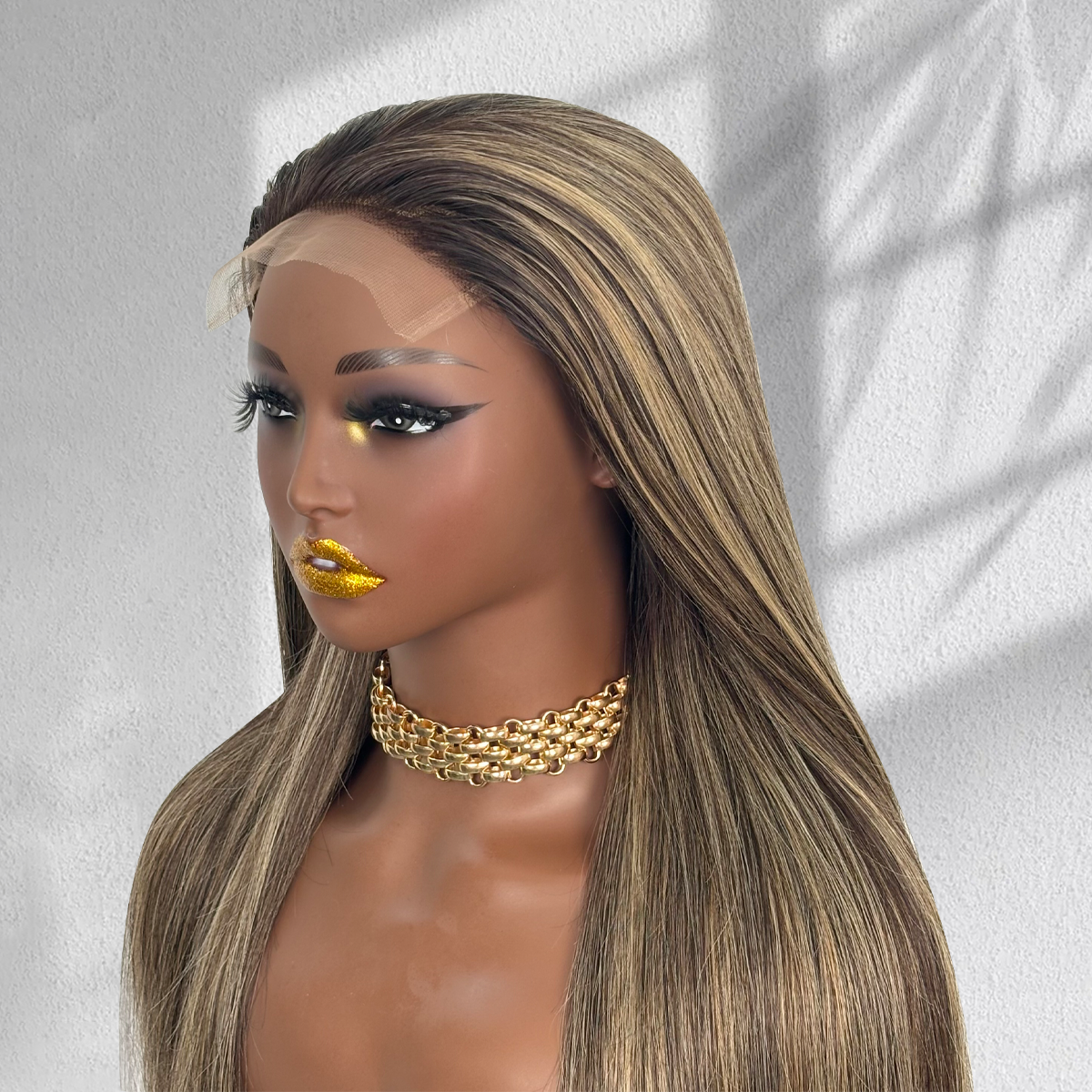 Angled view of a balayage HD lace wig on a mannequin, showing the hairline, dark roots and blonde highlights.