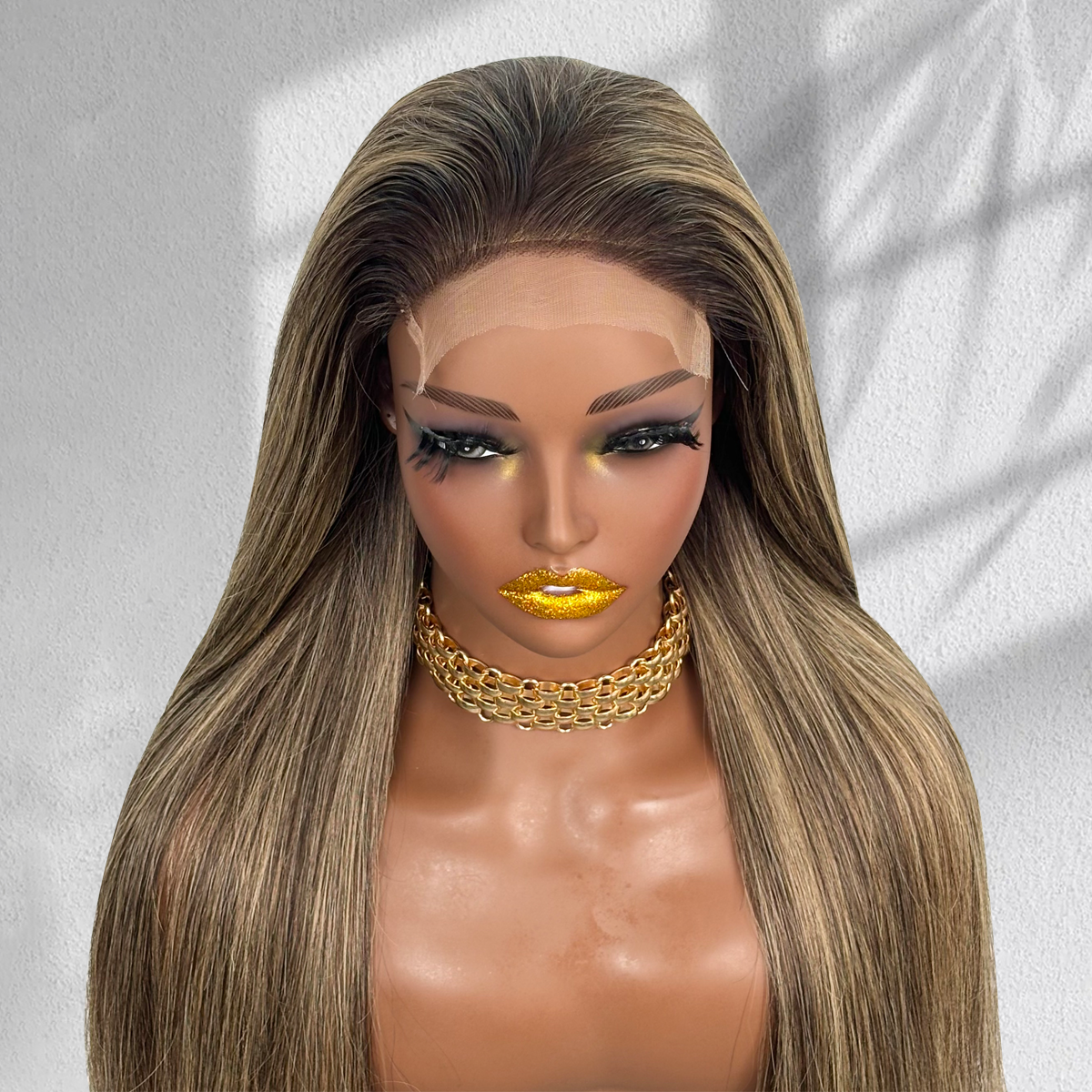 Front close-up of a straight balayage 5x5 HD lace wig showing the lace hairline and blonde face-framing highlights.