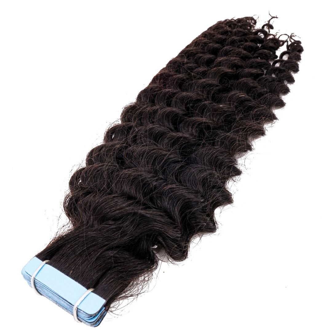 Close-up view of kinky curly tape-in extensions showcasing the natural curl pattern, ideal for 3B to 3C hair types.