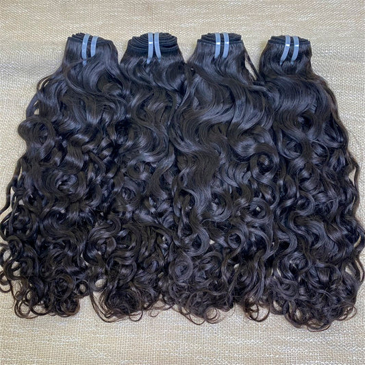 Three bundles of XBLhair Flawless Raw Hair Water Wave Human Hair on a textured background, with hair displayed in loose, curly strands.