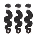 Three bundles of body wave black human hair extensions on white background