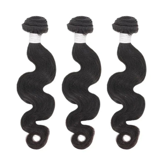 Three bundles of body wave black human hair extensions on white background