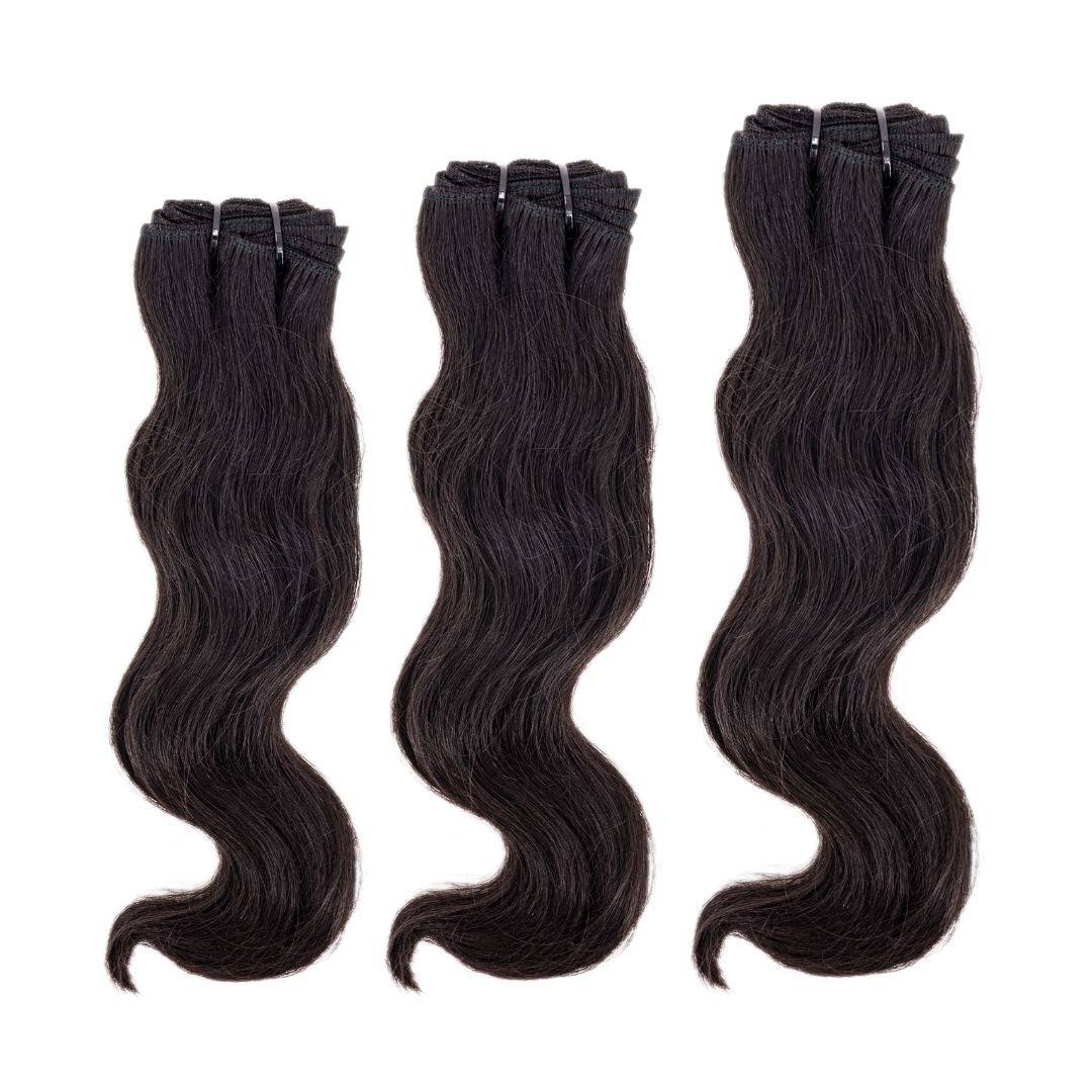 Raw Wavy Indian Hair Bundle Deal from Nikki Smith Hair Collection. 100% human hair weave in natural 12A wavy texture, available in lengths from 10” to 28”. Machine double stitch wefts for durability, with a raw grade for high-quality hair. Can lift to #613, sourced from temples in South East India.