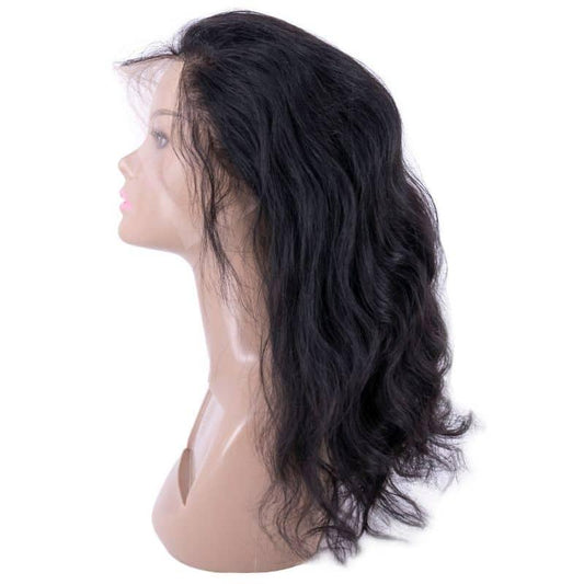 a Raw Indian Wavy wig made from 100% unprocessed human hair with a natural, effortless-looking texture. The wig is styled in a wavy pattern that falls just below the shoulders, with a subtle sheen and a light, airy feel. It is an excellent option for anyone seeking a premium, versatile hair replacement solution.