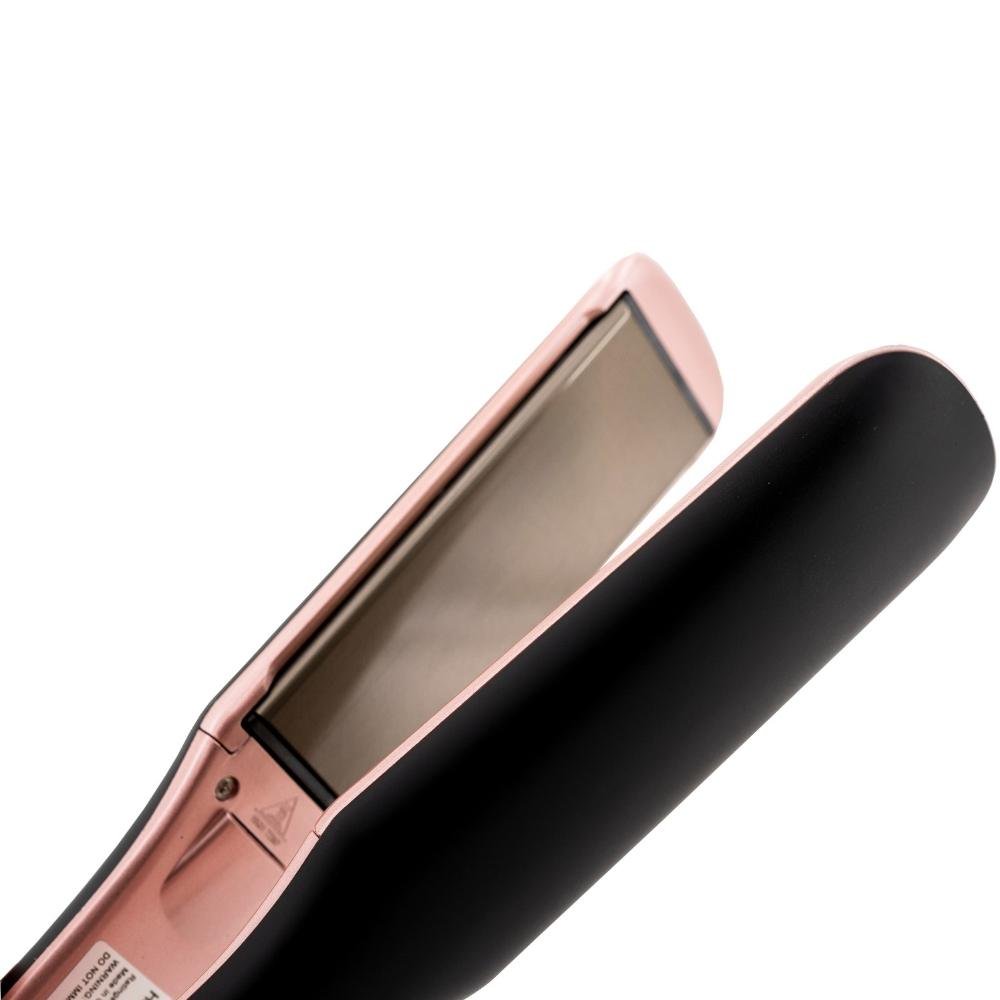 Close-up of the black and pink titanium flat iron, showcasing the titanium plates and professional styling capabilities.