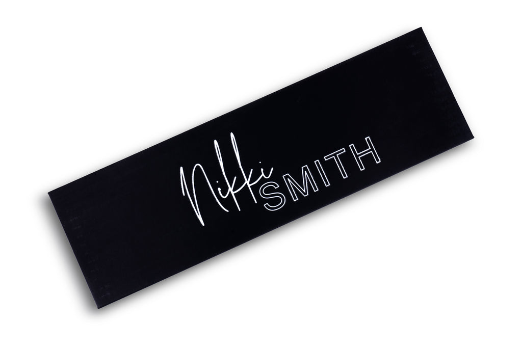Image focusing on the black and pink design of the titanium flat iron, with a focus on its 1.75-inch plates.
