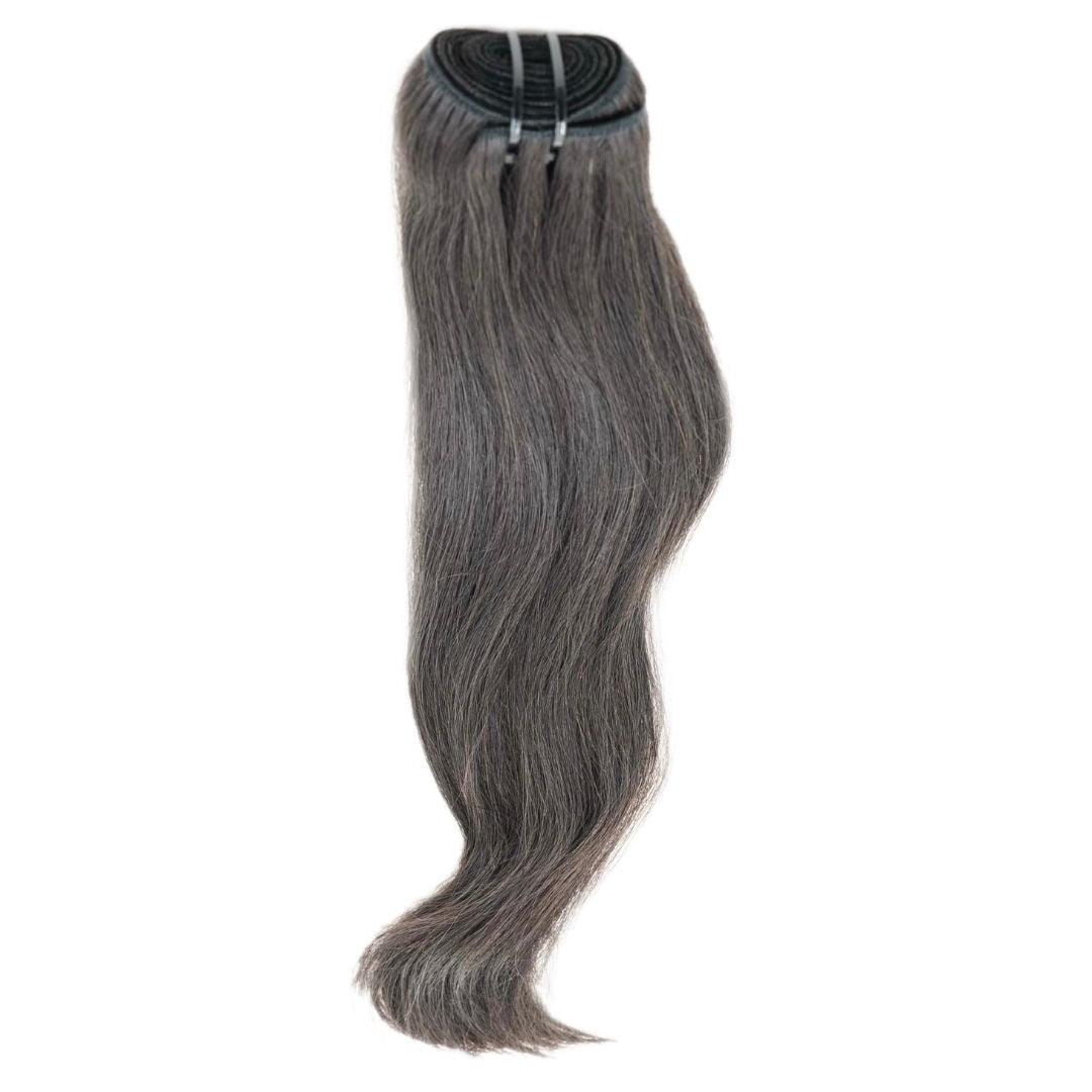 Raw Vietnamese Natural Gray Hair Extensions from Nikki Smith Hair Collection, made with 100% raw hair. Available in 14” to 22” lengths, offering a sophisticated gray color and lasting durability with proper care.